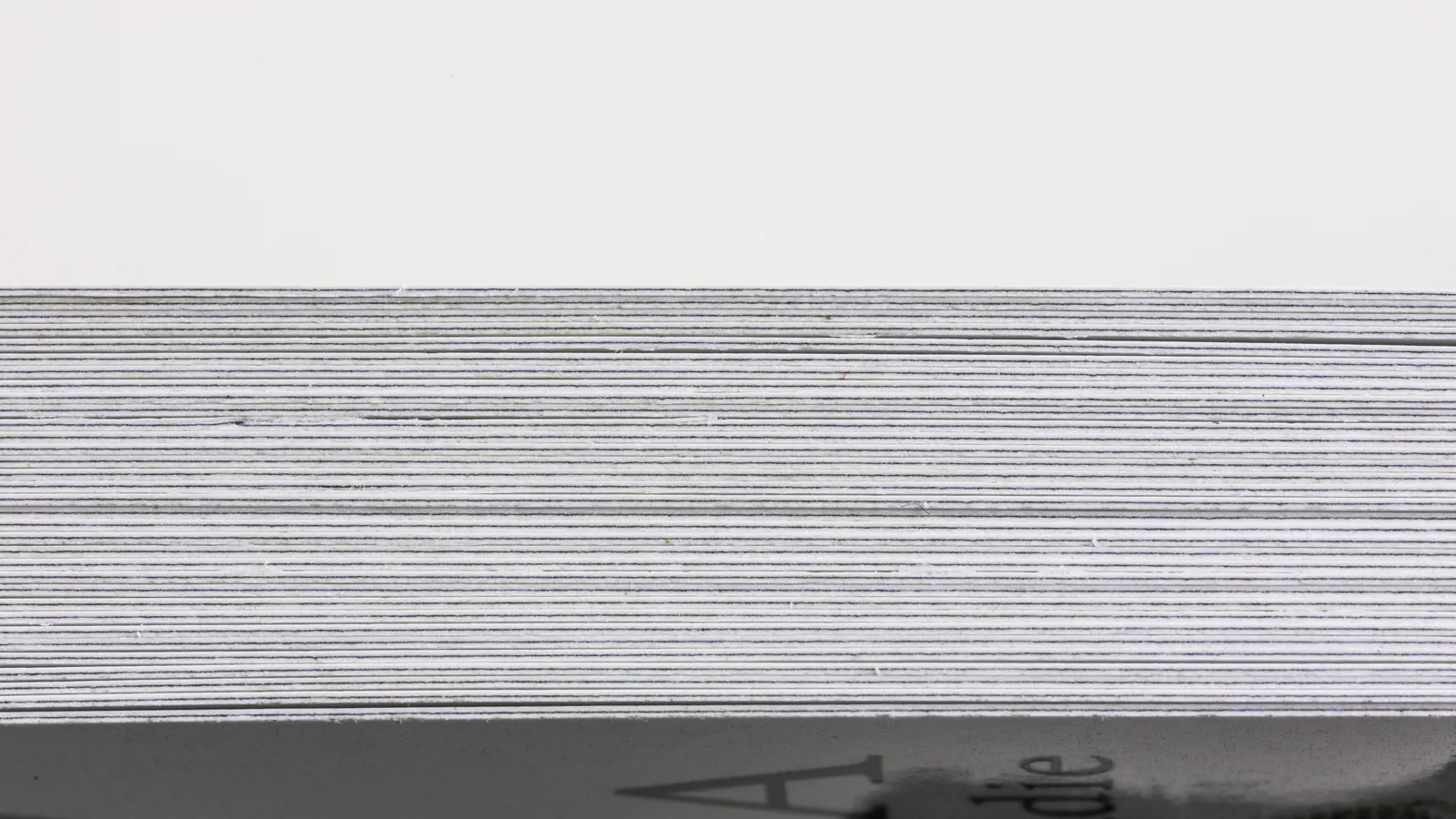 Side view of a finished custom playing card deck showing card stock layers