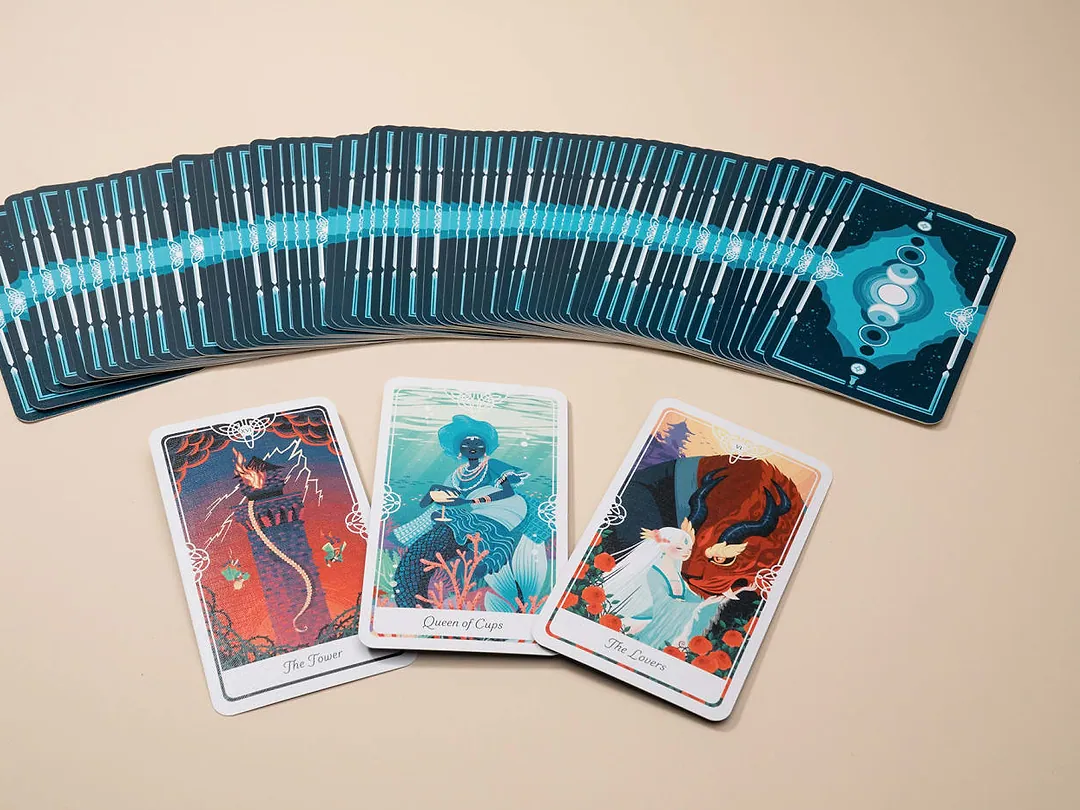 Custom tarot card deck fanned out with illustrated fronts and matching backs