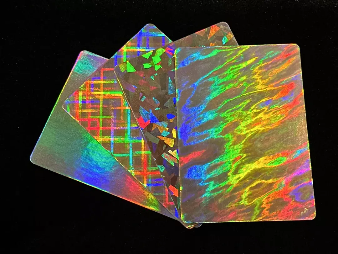 Close-up of custom holographic trading cards reflecting rainbow foil patterns